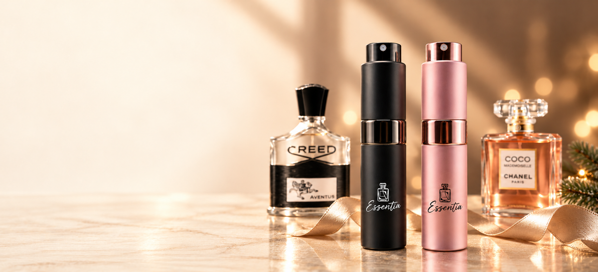 Essentia 10ml atomizers with original designer fragrance bottles behind them.