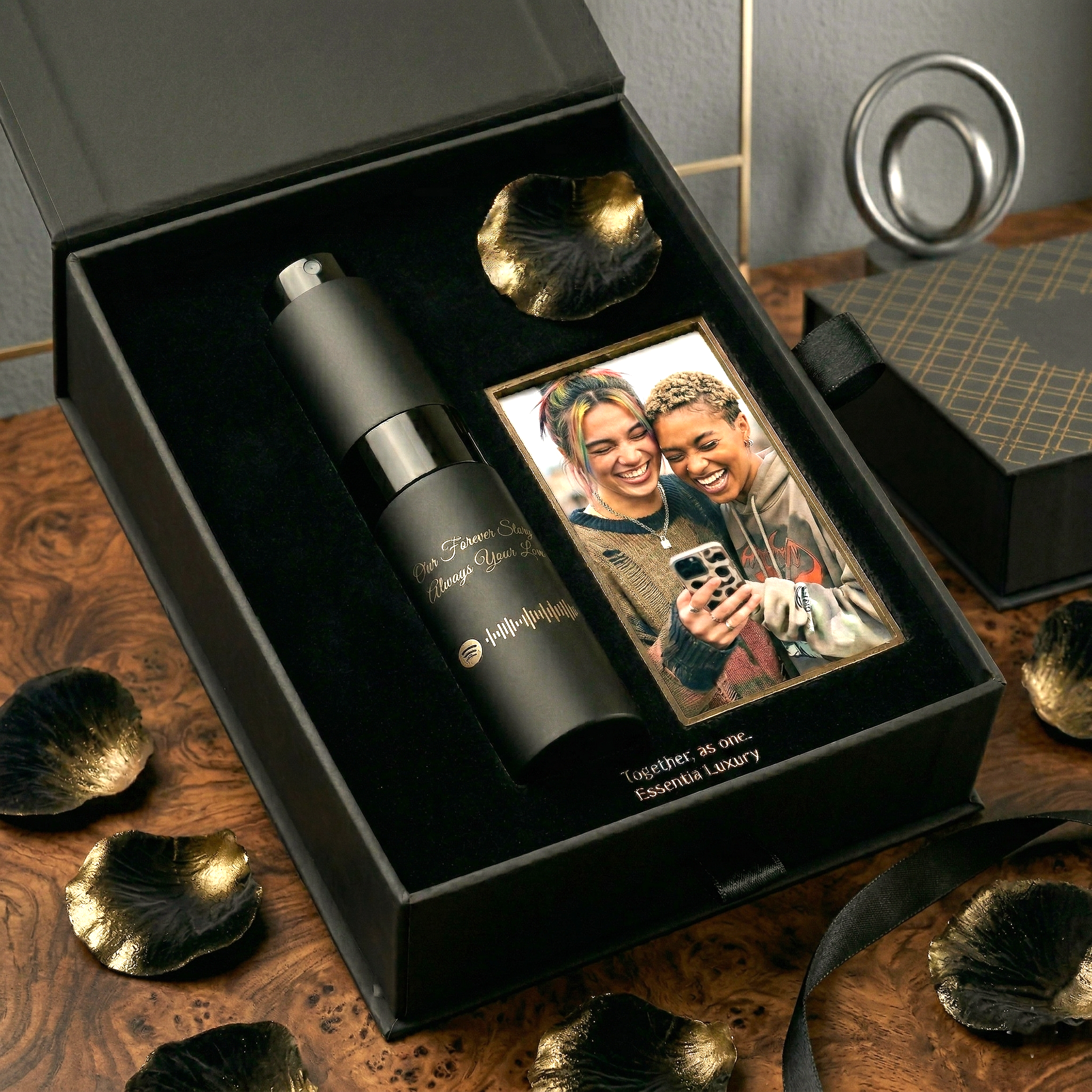 Black travel mug with decorative elements in a box on a wooden surface