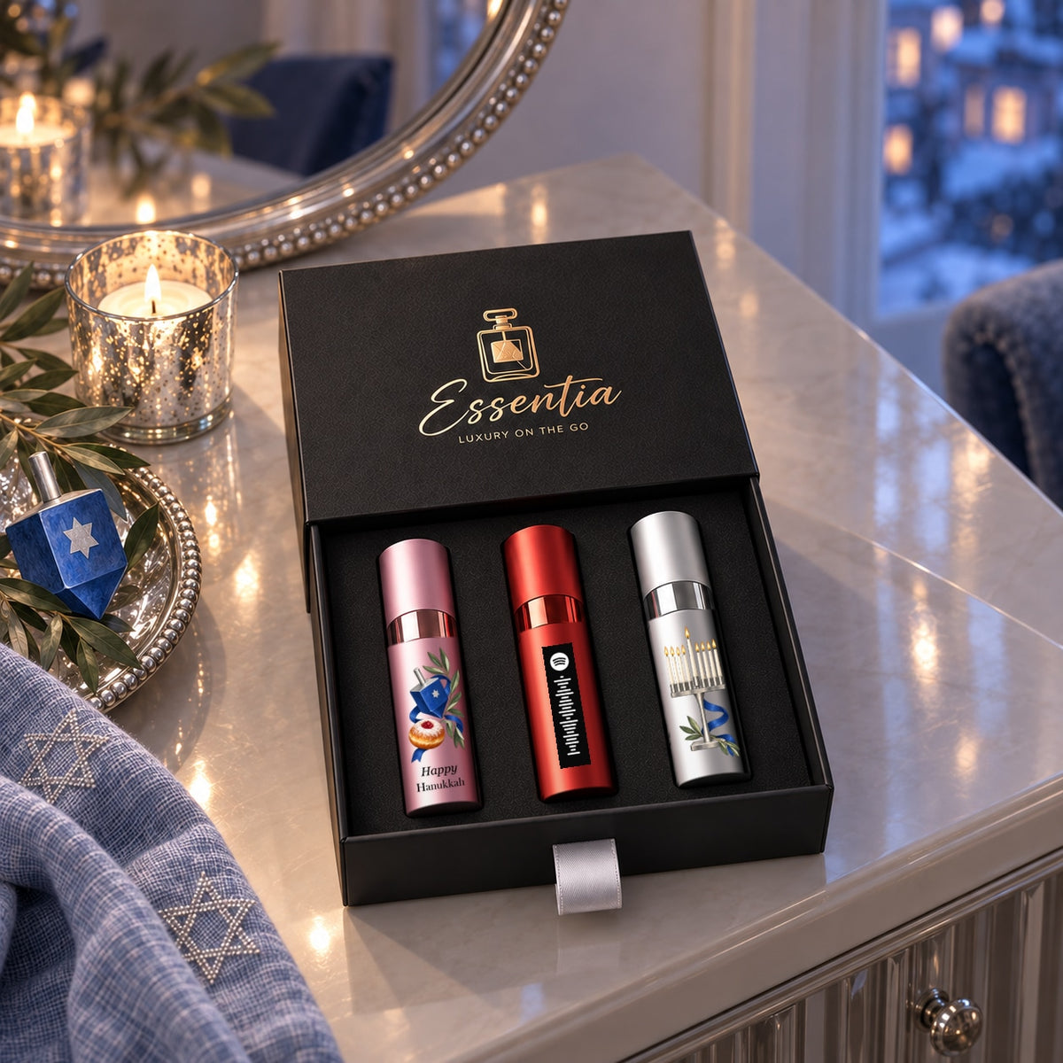 Hanukkah Fragrance Gift Set for Her — lifestyle. Original black Happy Hanukkah lettering on the pink atomizer and aligned shared motif.