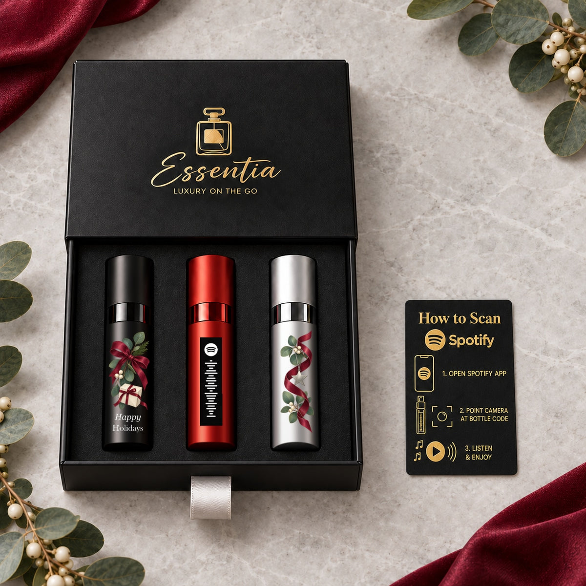 Happy Holidays Fragrance Gift Set for Him — included contents. Black, red and silver atomizers with festive artwork in the Essentia gift box.